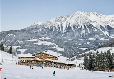 A cozy mountain restaurant in the Alps, surrounded by snow-capped mountains. Skiers and visitors enjoy the winter landscape.