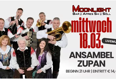 A group of musicians in traditional costumes stands together and plays instruments. A live music event with the ensemble Zupan is announced at the Moonlight bar in Söll.
