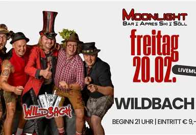 A group of five men in festive clothing poses for the camera. There is an event with live music at the Moonlight Bar in Söll on Friday, February 20.