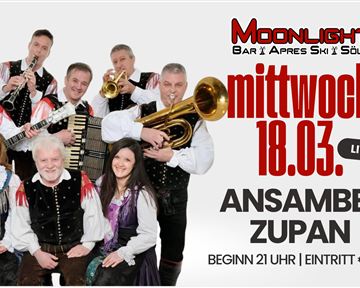 A group of musicians in traditional costumes stands together and plays instruments. A live music event with the ensemble Zupan is announced at the Moonlight bar in Söll.
