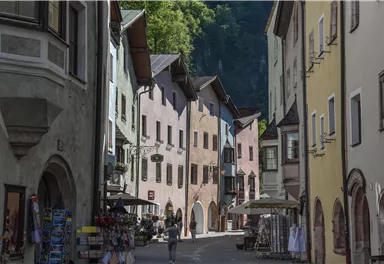 A picturesque street with colorful houses and an inviting ambiance. The trees in the background add a natural touch to the scene.