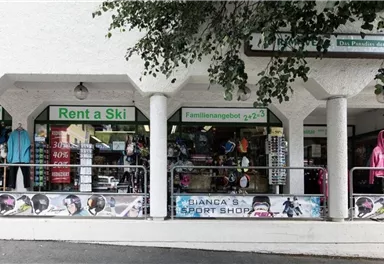 Ein Sportgeschäft mit Skiausrüstung und Bekleidung. Die Front ist einladend und zeigt verschiedene Angebote.