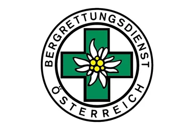 A logo of the Austrian Mountain Rescue Service. It features a green cross with an edelweiss flower in the center.