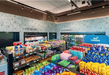 A well-organized store with fresh food and drinks. Colorful shelves with snacks and products attractively arranged.