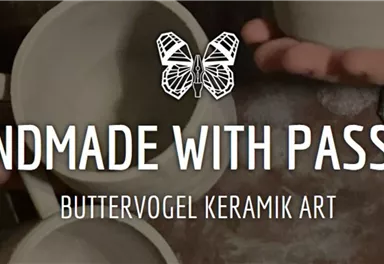 A handmade ceramic product is crafted with passion. The artists showcase mugs in a creative environment.