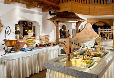 An elegant buffet with a variety of dishes and drinks. The tables are tastefully set and the atmosphere feels inviting.