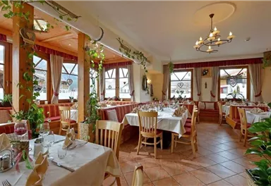 A cozy restaurant with wooden furniture and well-set tables.
Large windows provide plenty of natural light and a view of the surroundings.