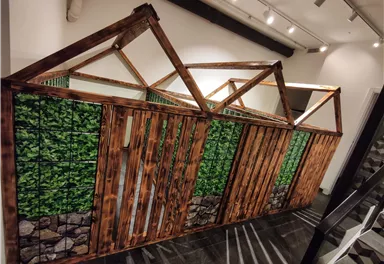 A creative wooden structure with plant motifs. It looks like a small building with a rustic design.