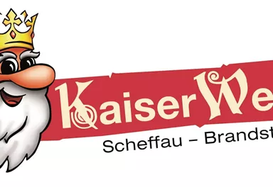 A cheerful logo featuring a smiling king and a crown. Below it says "KaiserWelt Scheffau - Brandstadl".