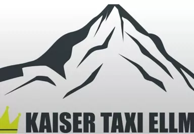 A modern logo of "Kaiser Taxi Ellmau" featuring stylized mountain peaks and a crown. The color shades are in black and green.