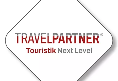 A logo from TravelPartner that carries the slogan "Tourism Next Level." It conveys a modern and dynamic travel experience.