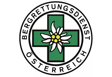 The logo of the Austrian Mountain Rescue Service features a green cross with an Edelweiss flower. The text surrounds the symbol and emphasizes the service.