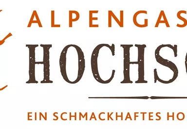 An inviting logo of the Alpengasthof Hochsöll featuring a stylized witch. The text emphasizes the culinary offerings and the coziness of the establishment.