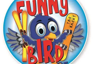A colorful sign with a funny bird holding skis. The text "FUNNY BIRD SLOPE" suggests a fun slope for skiers.
