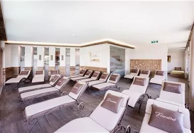 A bright relaxation room with loungers. The simple furniture and soft colors create a calm atmosphere.