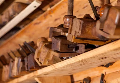 A set of wooden tools on a shelf. The tools show signs of use and give the scene a rustic charm.
