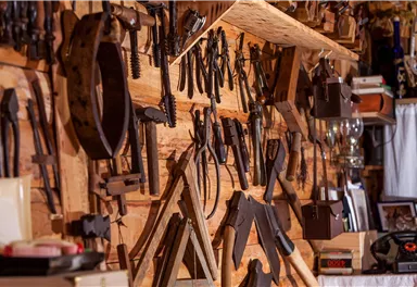 A wall full of handcrafted tools in a woodworking shop.
Various tools are neatly arranged, showcasing a creative work environment.