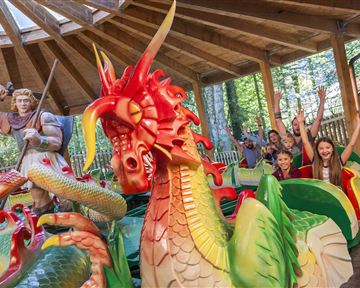 A colorful dragon park with cheerful children and a friendly knight. The atmosphere is lively and inviting.