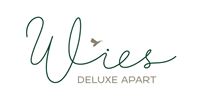 A stylish logo for "Wies Deluxe Apart". It features elegant lettering in green and gold with a charming bird motif.