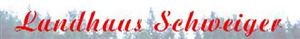A lettering with "Landhaus Schweiger" in red color. Blurry trees are visible in the background.