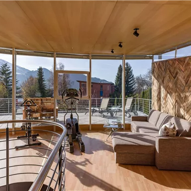 A modern room with large windows and a beautiful view of the mountains. Cozy furniture and a stylish design create an inviting atmosphere.