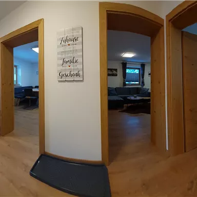 A hallway with several doors leading to different rooms. The walls are bright and there is a cozy atmosphere.