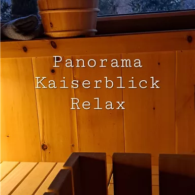 A relaxing view of the mountains from a cozy room. The wooden details and sauna amenities invite you to unwind.