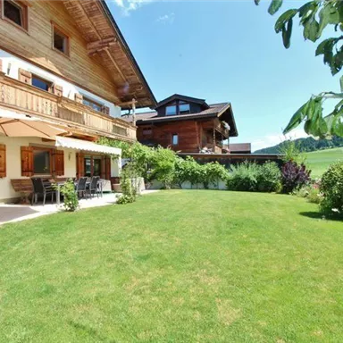 A beautiful house with a large meadow and well-maintained garden. The surroundings are green and sunny, ideal for relaxing days outdoors.