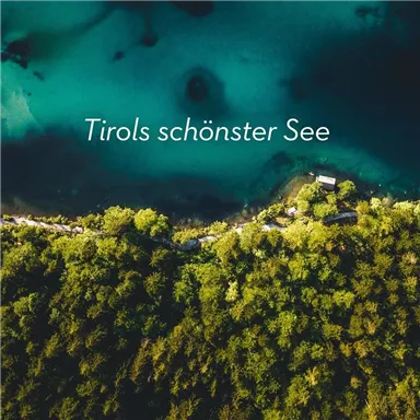 A beautiful lake in Tyrol, surrounded by lush greenery. The turquoise water invites you to relax.