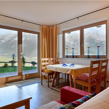 A cozy living space with a view of the mountains. The large windows let in plenty of light and create an inviting atmosphere.