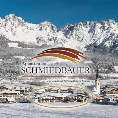 A picturesque winter landscape with snow-covered mountains and a small village. In the foreground, the Schmiedbauer apartment is depicted.