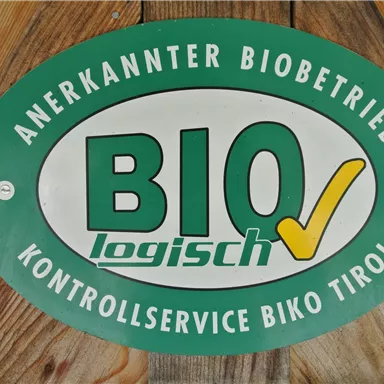 A green sign with the text "Recognized Organic Farm" and the logo "BIO logically". It indicates the certification for organic products in Tyrol.