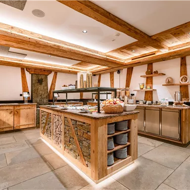 Ein stilvolles Buffet mit Holzregalen und einer gemütlichen Atmosphäre. Der Raum ist gut beleuchtet und lädt zum Verweilen ein.