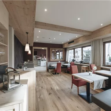 Ein modernes Restaurant mit Holzdekor und großen Fenstern. Die Einrichtung ist stilvoll und gemütlich.