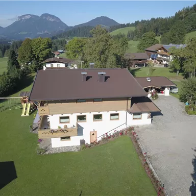 A beautiful former farmhouse in a quiet rural setting. Surrounded by green meadows and mountains in the background.