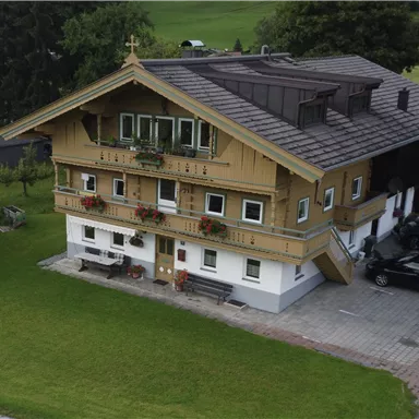 A traditional wooden house with balconies and flower boxes.