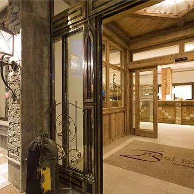 The reception area of a stylish hotel with wooden paneling and elegant lighting. An inviting atmosphere with modern design.