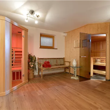 A cozy wellness area with a sauna and wooden paneling. The decor is modern and inviting, perfect for relaxation.