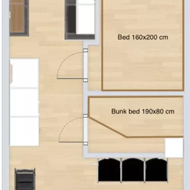 Eine Grundrisszeichnung einer Wohnung mit zwei Schlafzimmern und einem Badezimmer. Das Design zeigt eine offene Wohnküche und Sitzgelegenheiten im Wohnzimmer.