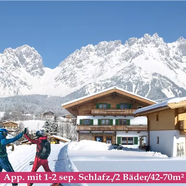 A picturesque winter landscape with snow-covered mountains and traditional chalets. Two skiers are joyfully facing each other.
