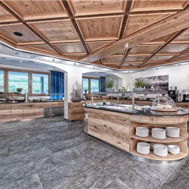 A modern buffet with wooden shelves and elegant design. The large window front provides plenty of daylight.
