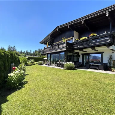 A beautiful house with a large garden and a sunny terrace. The surroundings are green and inviting.