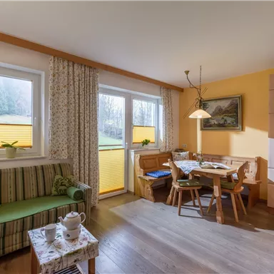 A cozy living kitchen with dining area and lounge corner