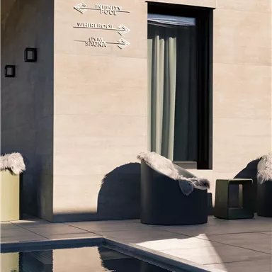 A modern terrace with a pool and stylish seating. In the background, windows with curtains can be seen.