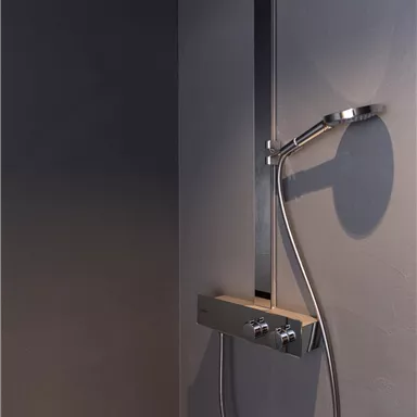 A modern shower with an elegant shower head and a handheld shower holder. The walls are in a simple, dark tone.