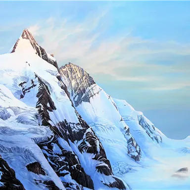 An impressive mountain landscape with snow-covered peaks and a clear sky. The mountains radiate a majestic tranquility.