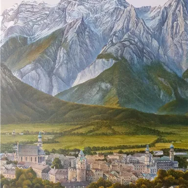 A picturesque view of a city in the valley, surrounded by high mountains. The gentle hills and the impressive peaks create an idyllic landscape.