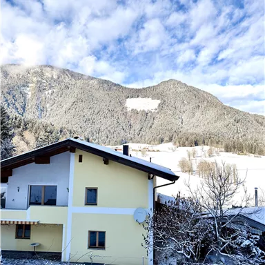 In this yellow house, all 3 apartments are located. You can experience this landscape in winter in Söll.