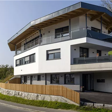 A modern building with unique architecture. It is located in a quiet area with a view of the mountains.