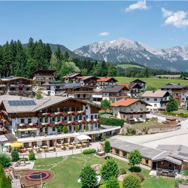 Aerial view of Hotel Alpenpanorama with surrounding mountain scenery and sun terrace.